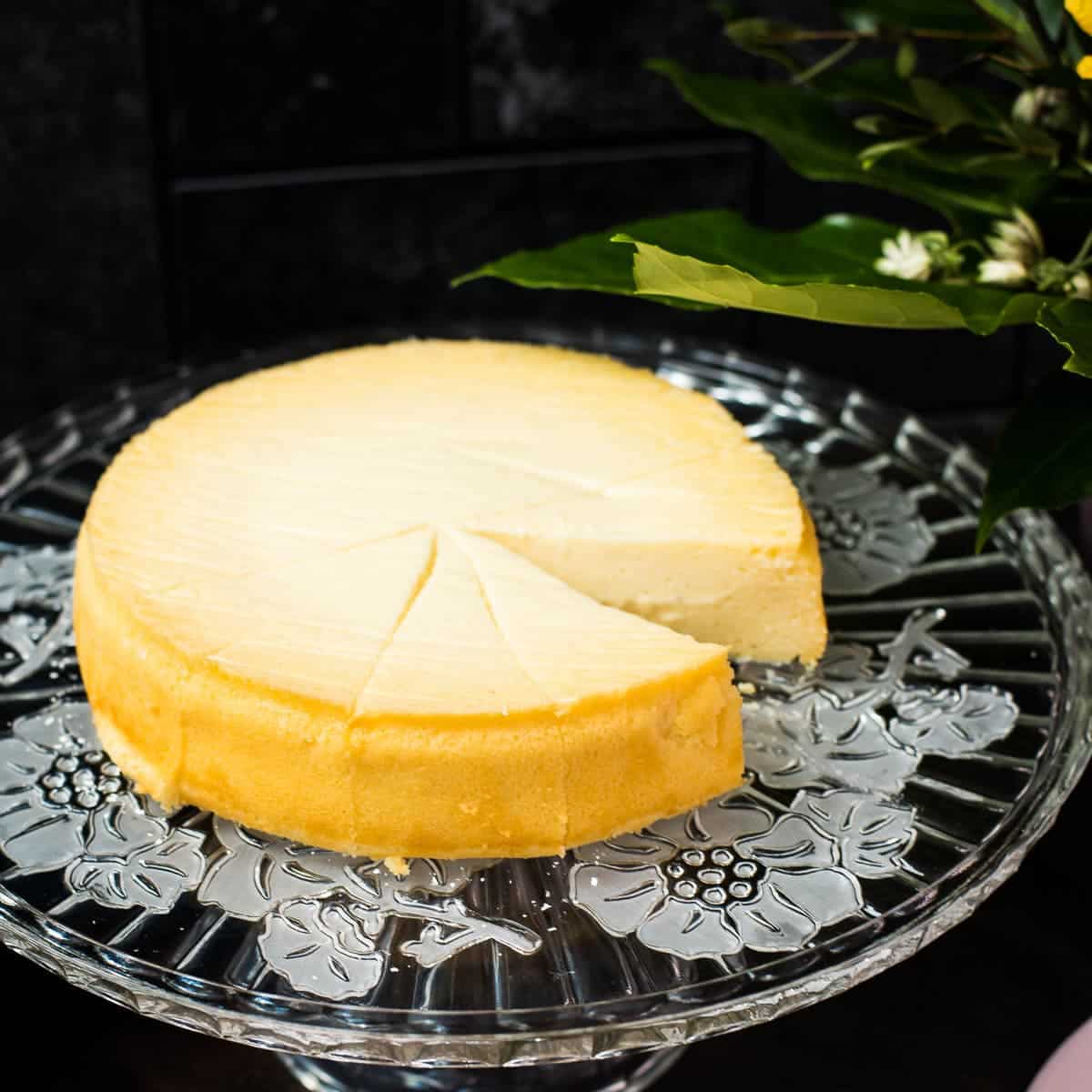 Three ingredient yogurt cake on gorgeous glass cake plate.