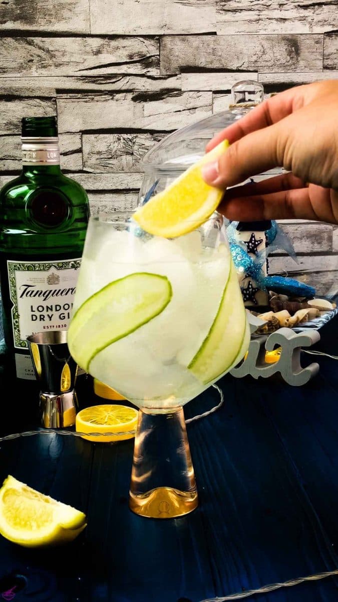 Add ta lemon wedge on top of your cucumber gin and tonic.