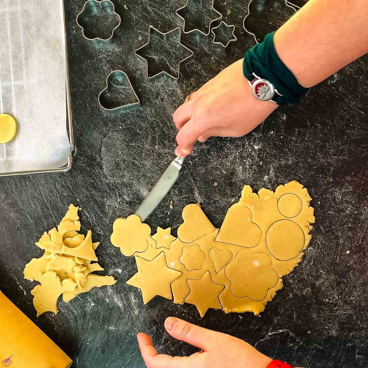 If you don't have a spatula, use a butter knife to loosen the cut-out cookies from the kitchen counter surface.