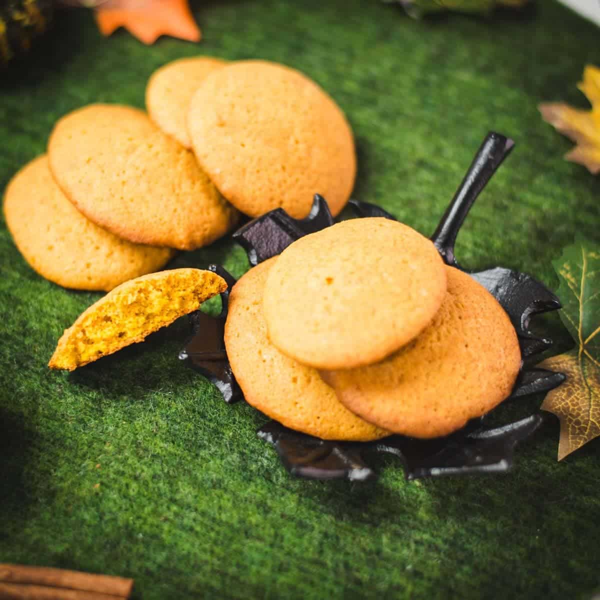 Super soft and delicious pumpkin cookies placed on black leaf shaped dish.
