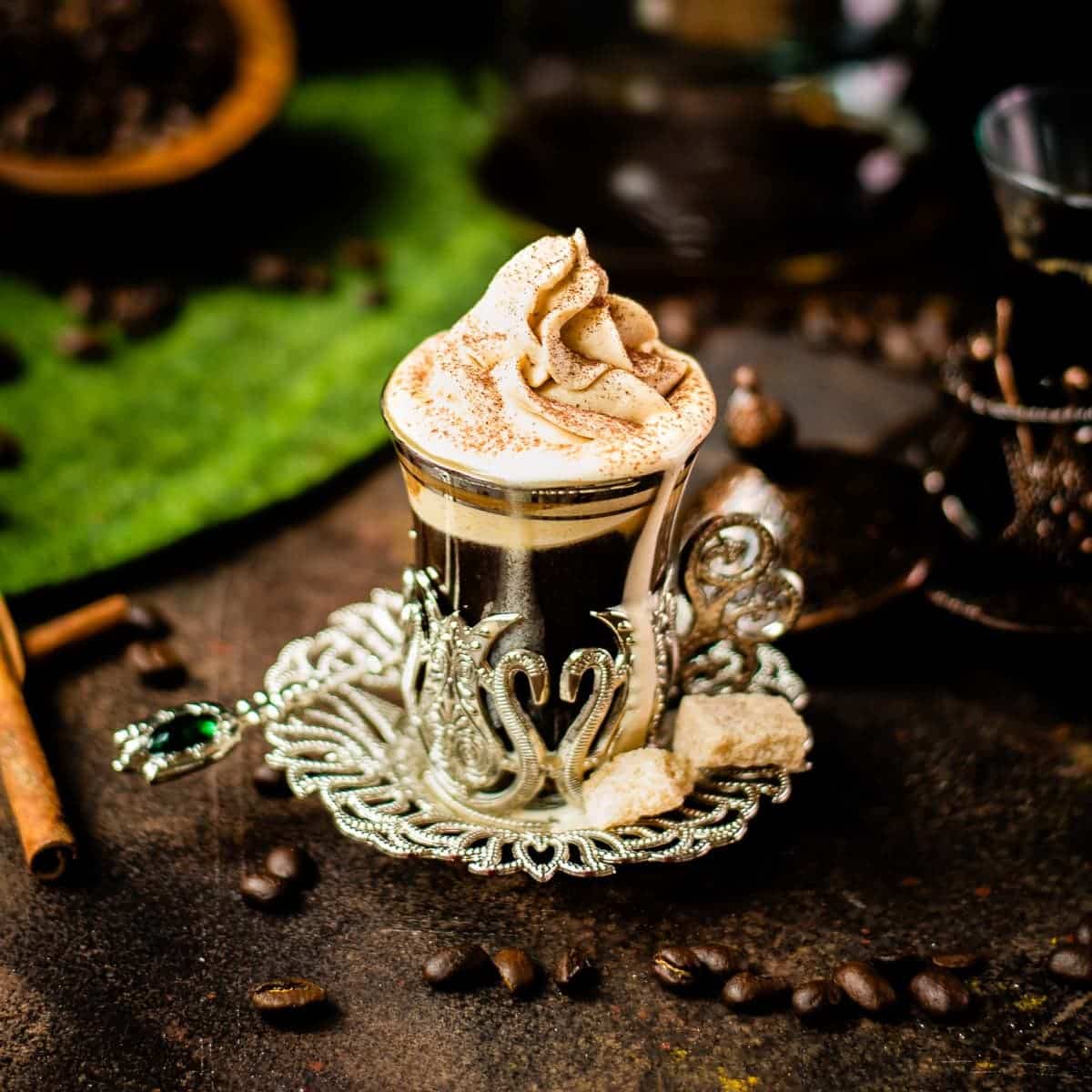Gorgeous medieval glass filled with coffee and topped with pumpkin flavored whipped cream.