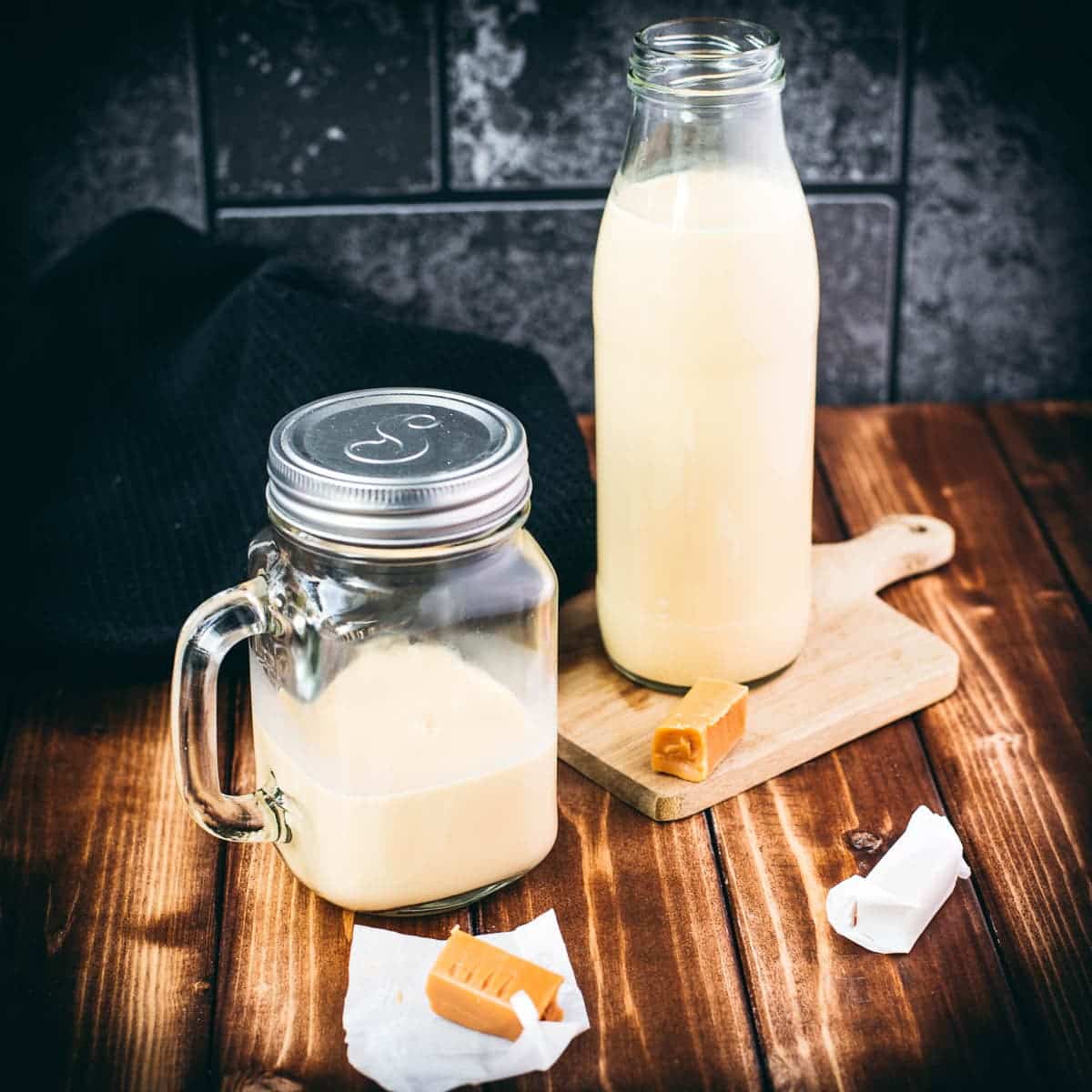 Mason jar and preserving bottle filled with delicious salted caramel coffee creamer.