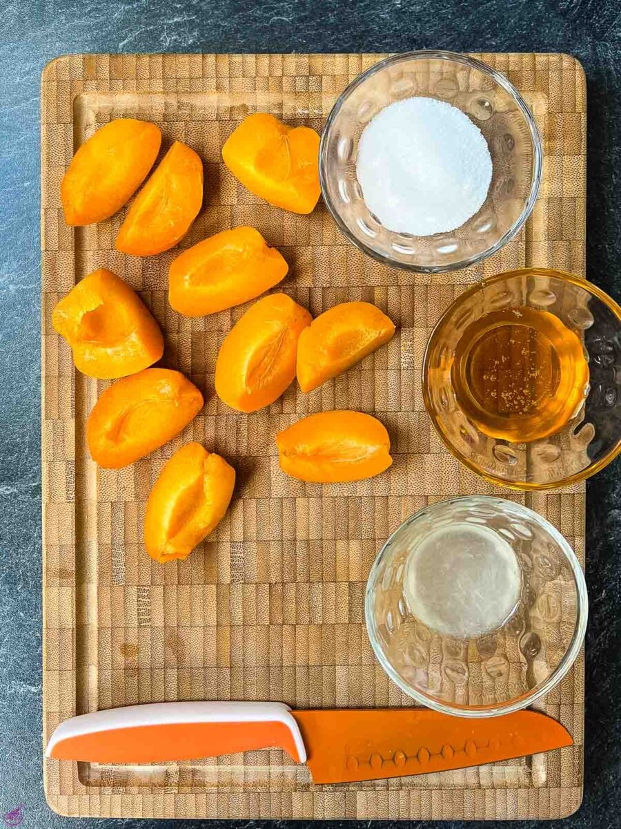 5 simple ingredients are required for making a delicious apricot compote - water, sugar, honey, apricots, and lemon juice.