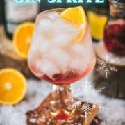 Stunning cranberry gin spritz, garnished with a slice of orange. Refreshing and festive!