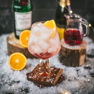 Stunning cranberry gin spritz, garnished with a slice of orange. Refreshing and festive!