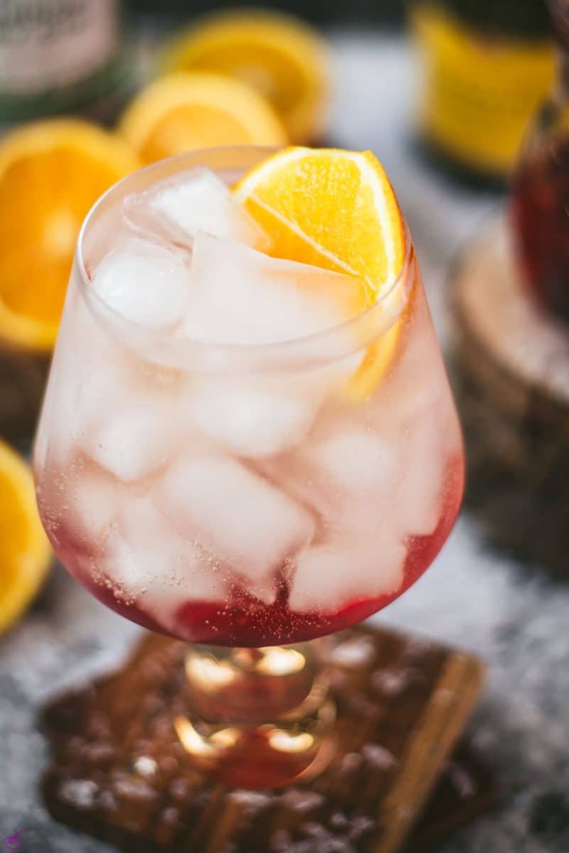 Stunning cranberry gin spritz, garnished with a slice of orange. Refreshing and festive!