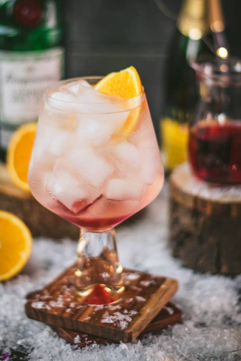 Stunning cranberry gin spritz, garnished with a slice of orange. Refreshing and festive!