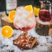 Stunning cranberry gin spritz, garnished with a slice of orange. Refreshing and festive!