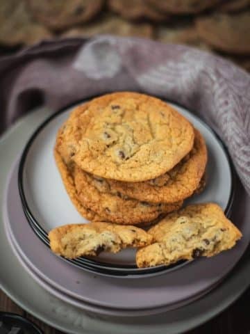 Delicious rum chocolate chip cookies placed on different colored and sized plates.