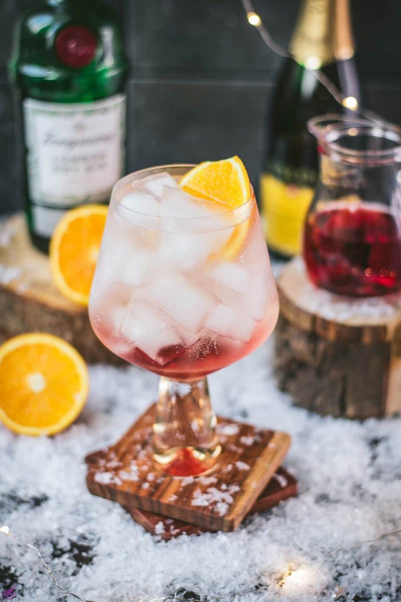 Stunning cranberry gin spritz, garnished with a slice of orange. Refreshing and festive!