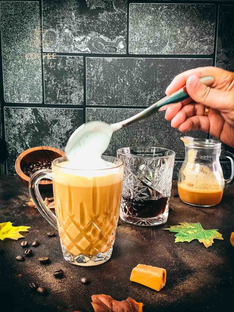 Add the frothed milk on top of the caramel coffee.