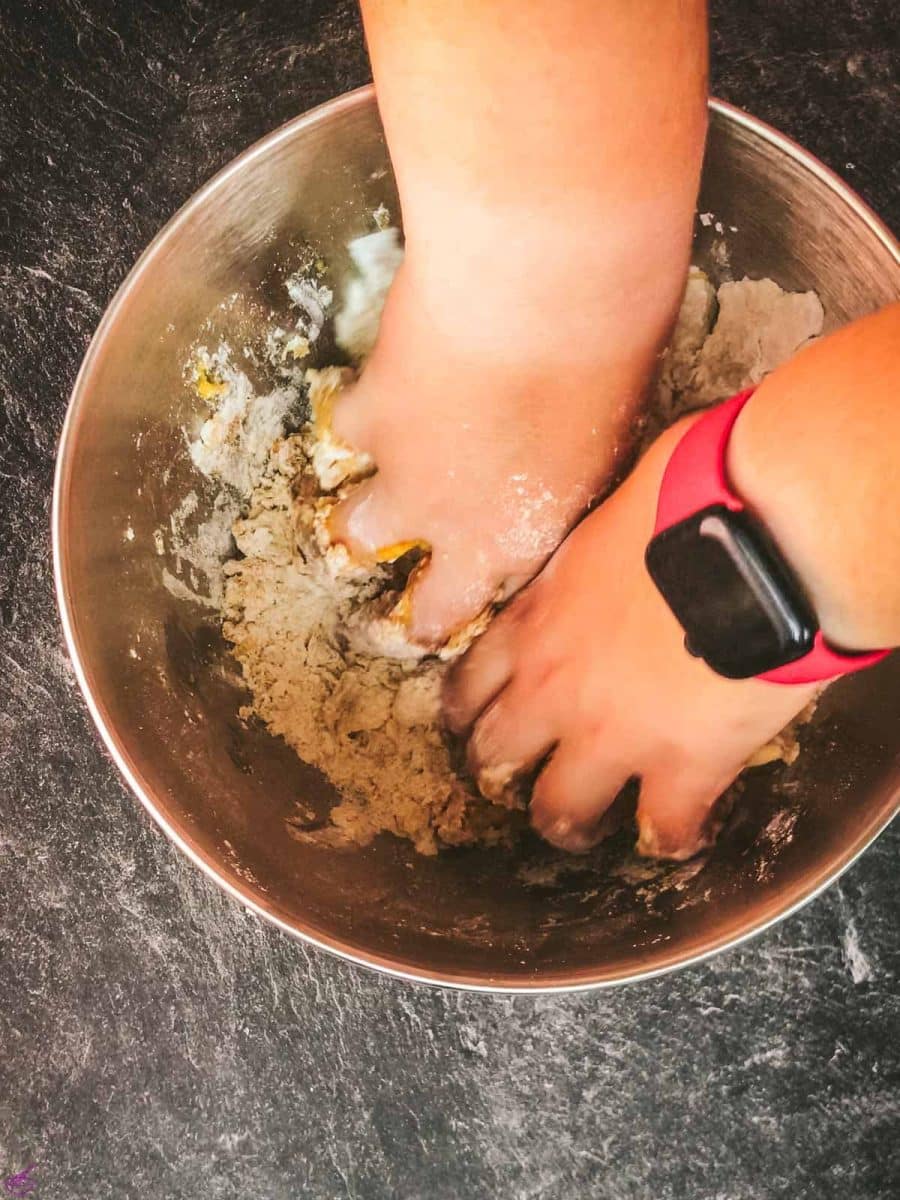 Either mix the dough by hand or with a stand mixer, attached with a dough hook.