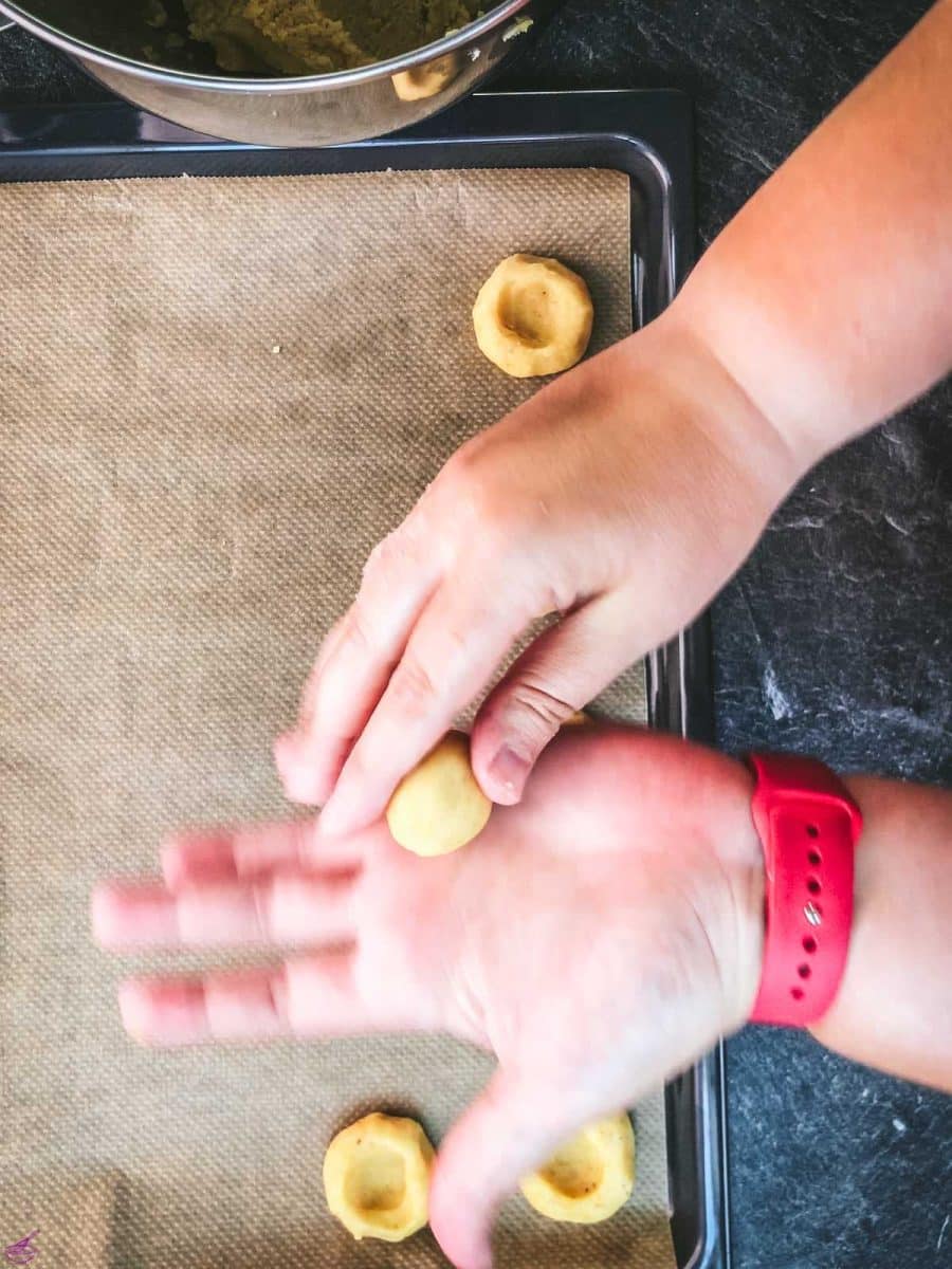 Roll the cut out dough between your hands, creating a small cookie ball.