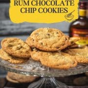 Delicious rum chocolate chip cookies placed on glass plate, next to a bottle of Myers's rum.