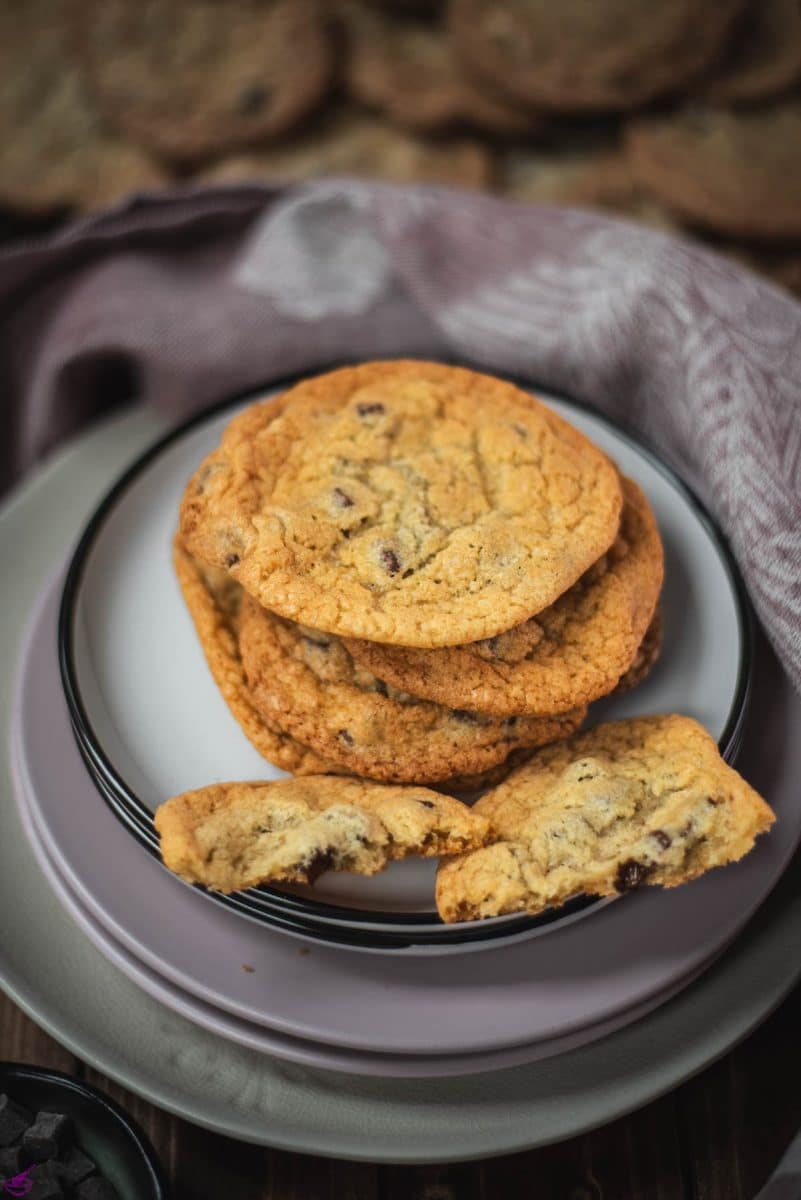 Delicious rum chocolate chip cookies placed on different colored and sized plates.