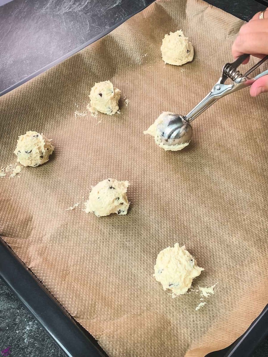 Scoop the dough into balls and evenly space them on a lined baking sheet.