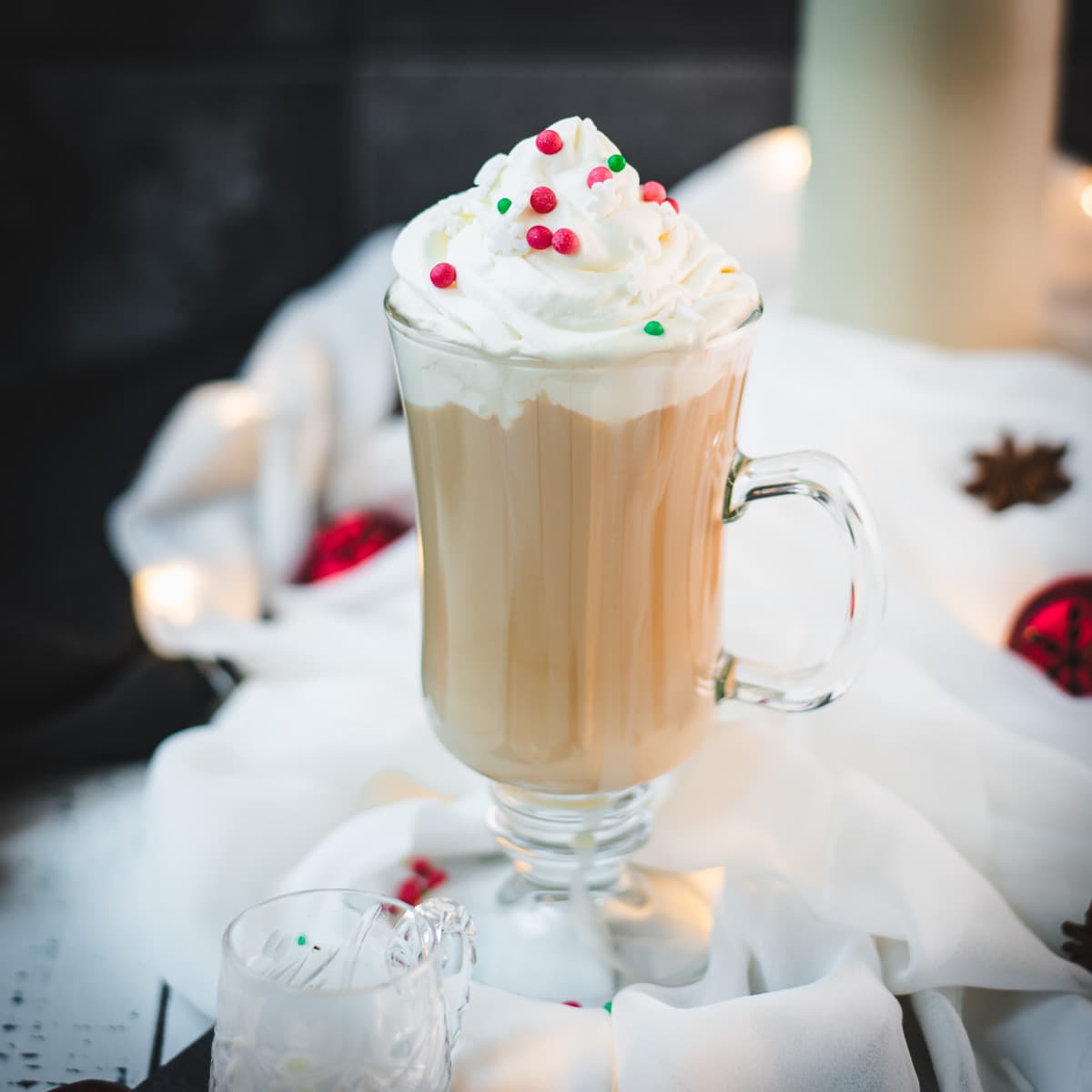 Christmas coffee made with delicious Christmas coffee creamer served in gorgeous glass and served with red and green sprinkles.