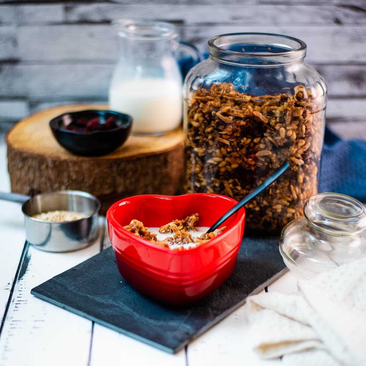 Gorgeous heart shaped breakfast bowl, filled with delicious maple cinnamon granola with milk.