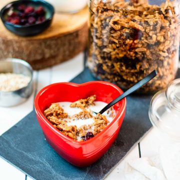 Gorgeous heart shaped breakfast bowl, filled with delicious maple cinnamon granola with milk.