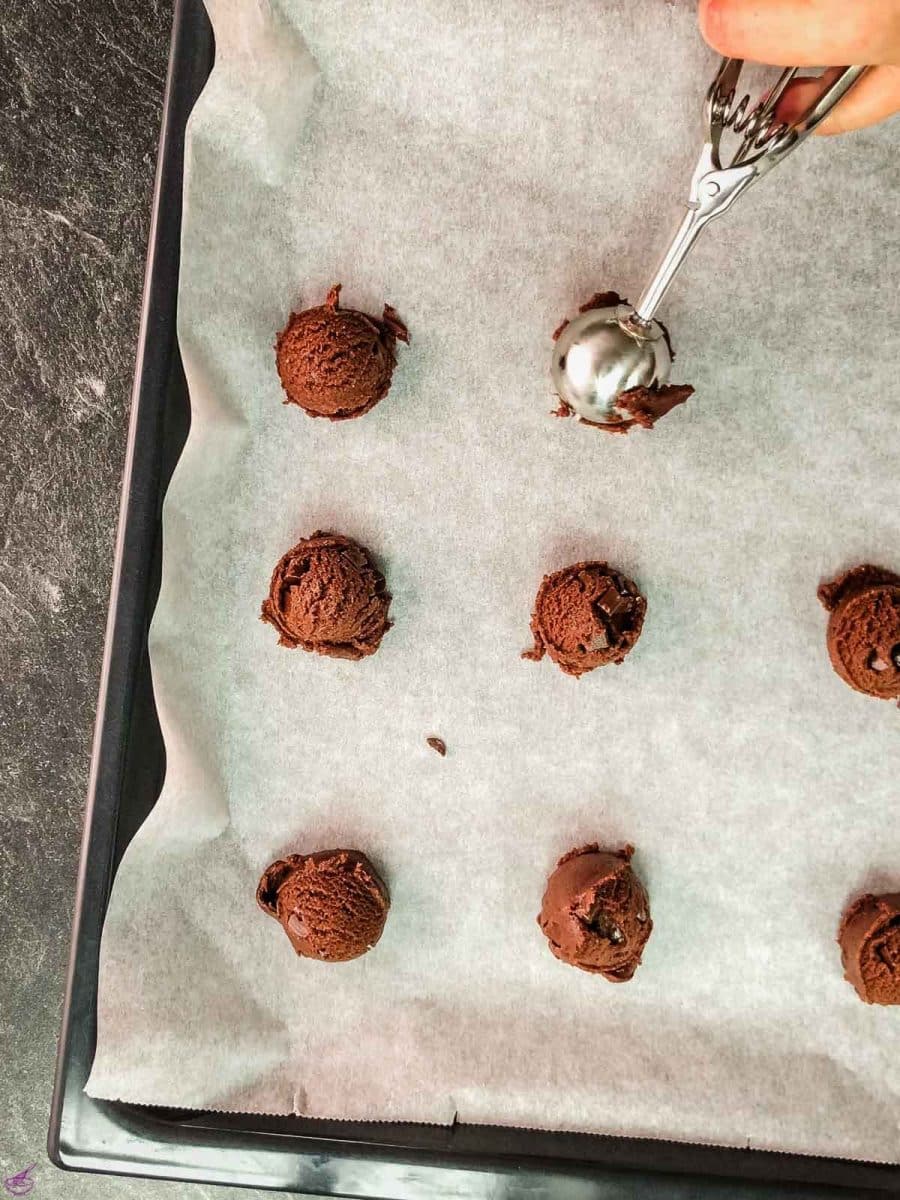 Scoop the cookie dough on the baking sheet lined with parchment paper.