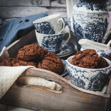 Beautiful coffee chocolate chip cookies, on blue white porcelain.