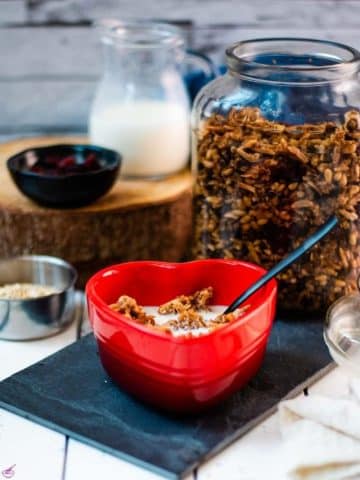 Gorgeous heart shaped breakfast bowl, filled with delicious maple cinnamon granola with milk.