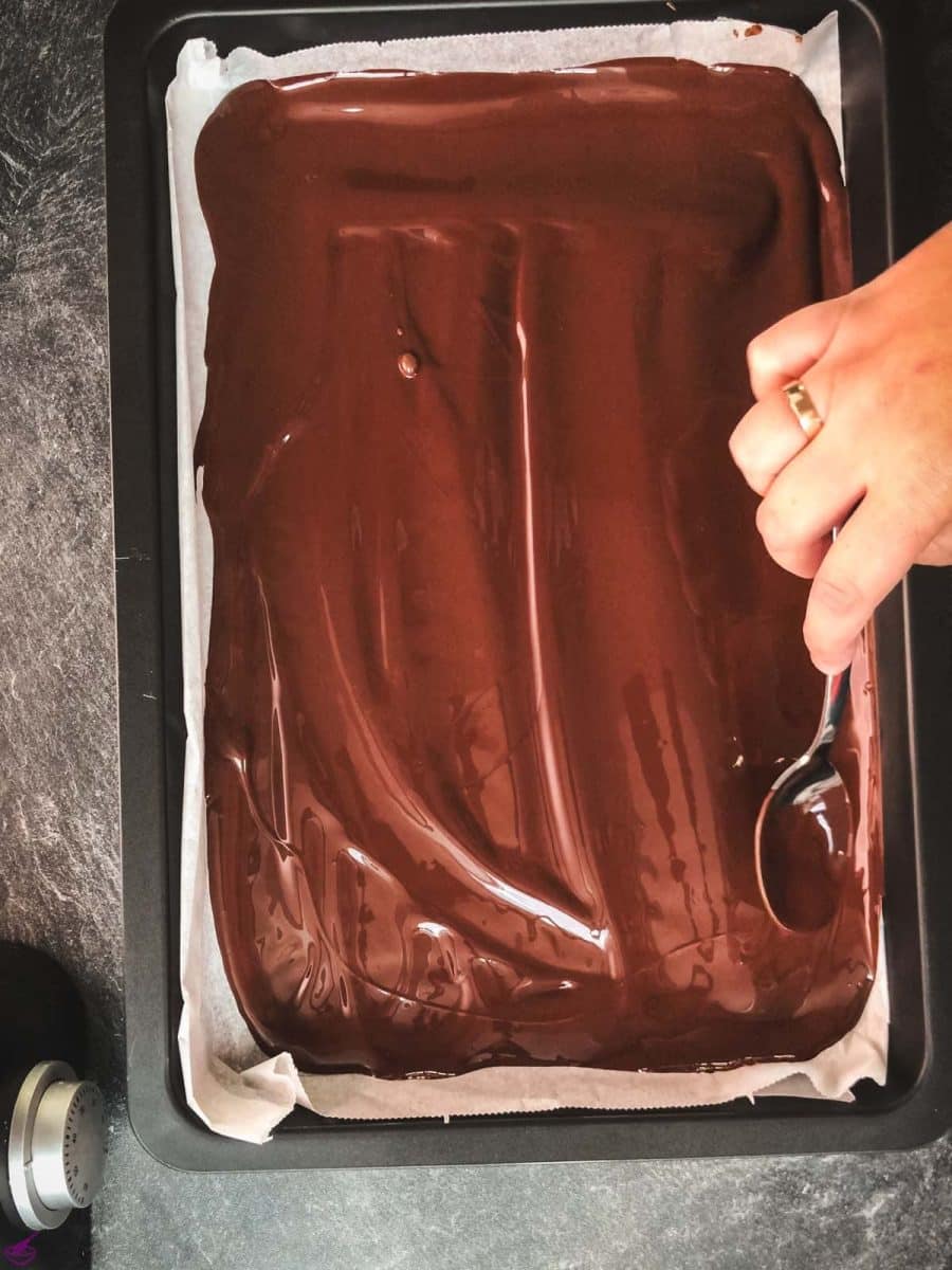 Spread the dark chocolate on a sheet pan, lined with parchment paper.