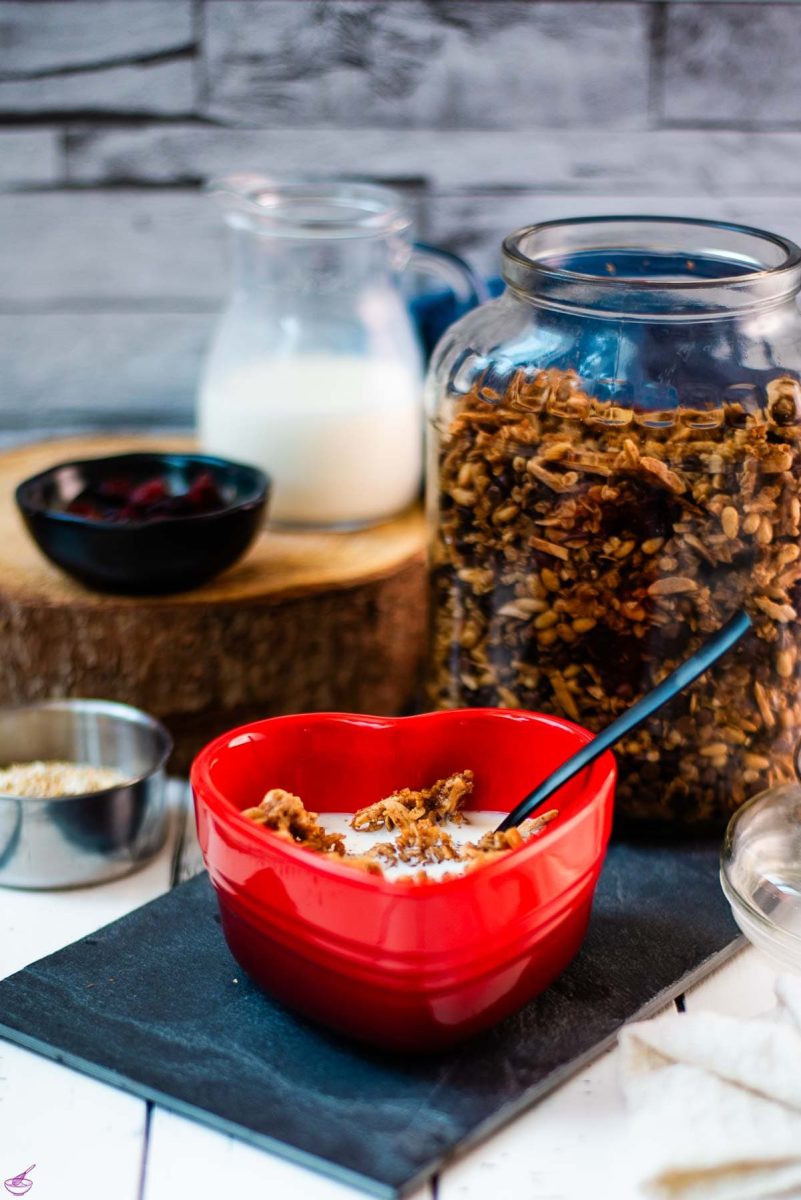 Gorgeous heart shaped breakfast bowl, filled with delicious maple cinnamon granola with milk.