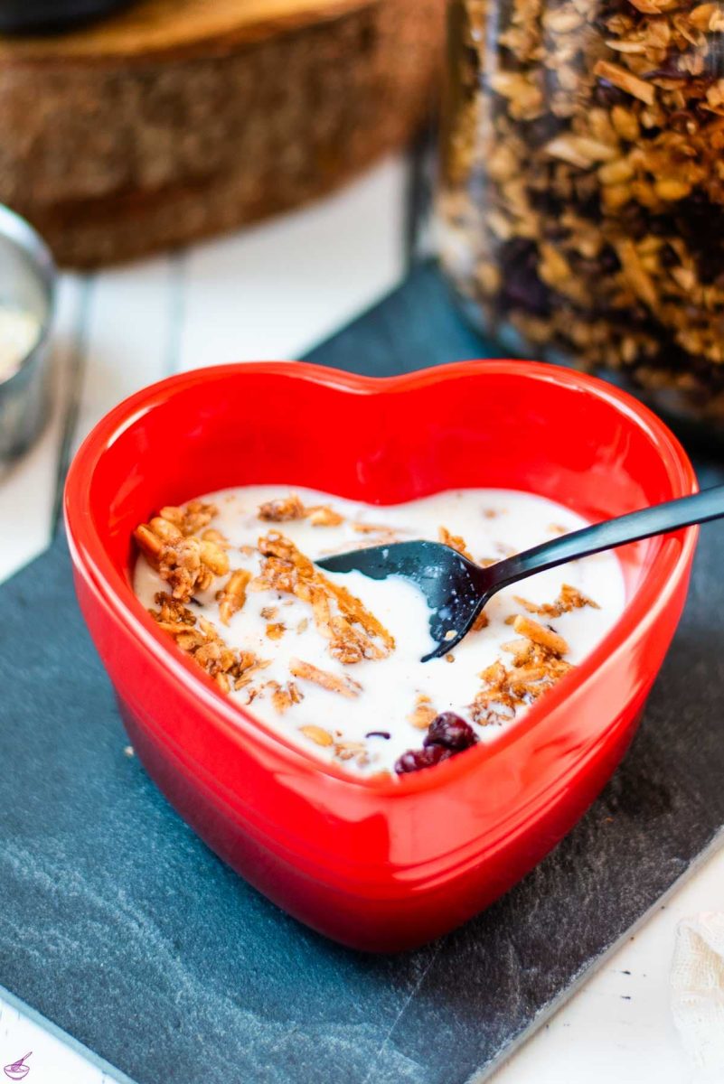 Gorgeous heart shaped breakfast bowl, filled with delicious maple cinnamon granola with milk.