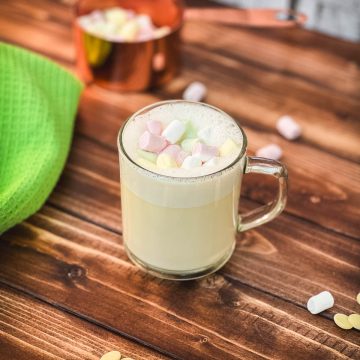 Glass cup filled with scrumptious white hot chocolate. Topped with frothed white chocolate and garnished with mini marshmallows.