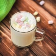 Glass cup filled with scrumptious white hot chocolate. Topped with frothed white chocolate and garnished with mini marshmallows.