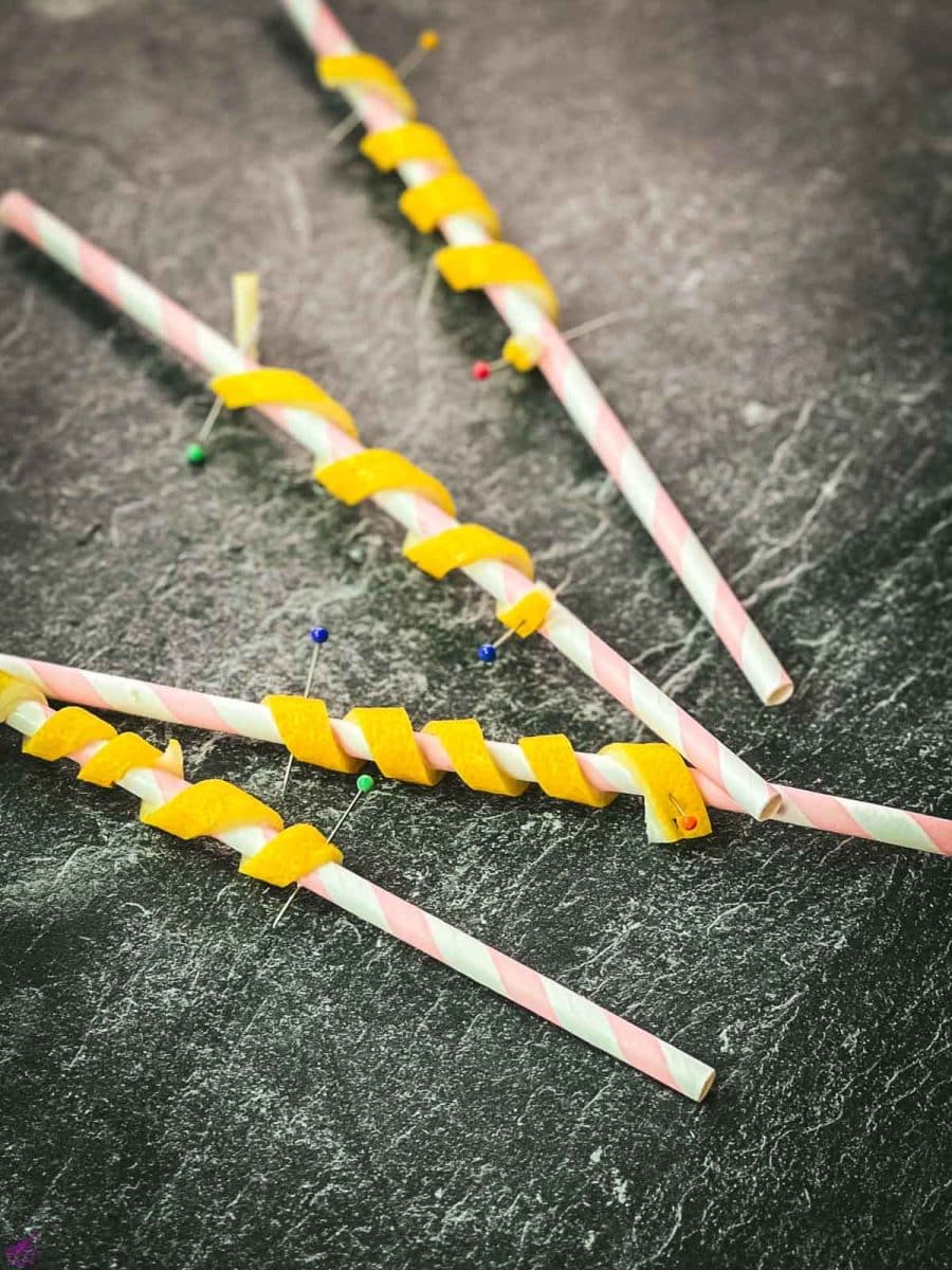 Finished lemon twists pinned on paper straw.