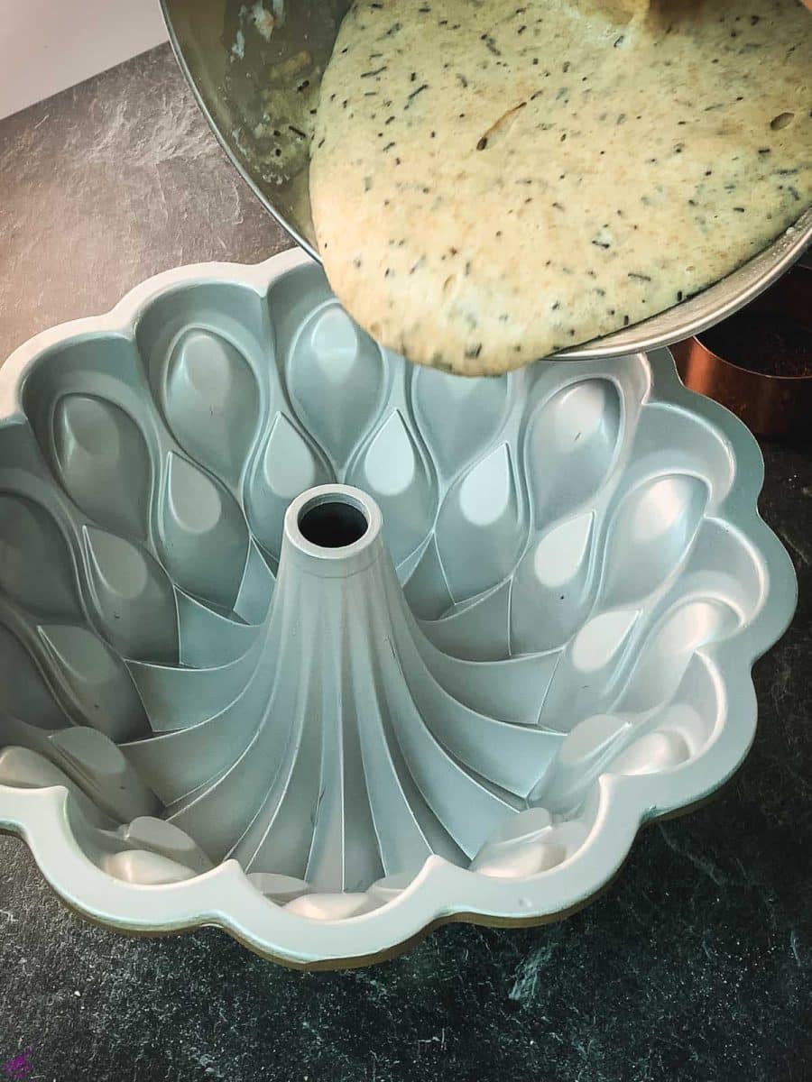 Pour half of the cake batter into the bundt cake pan.