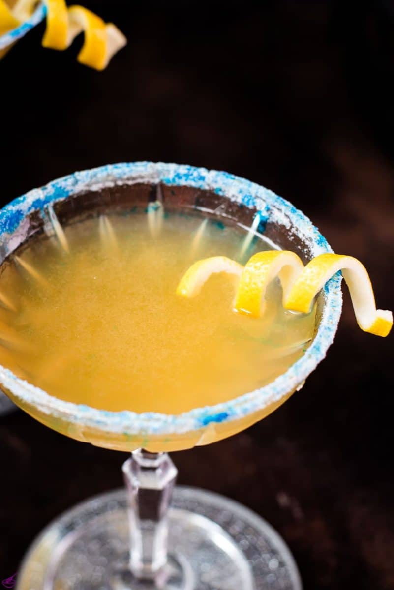 Whisky sidecar with gorgeous lemon twist and white blue sugar rim.