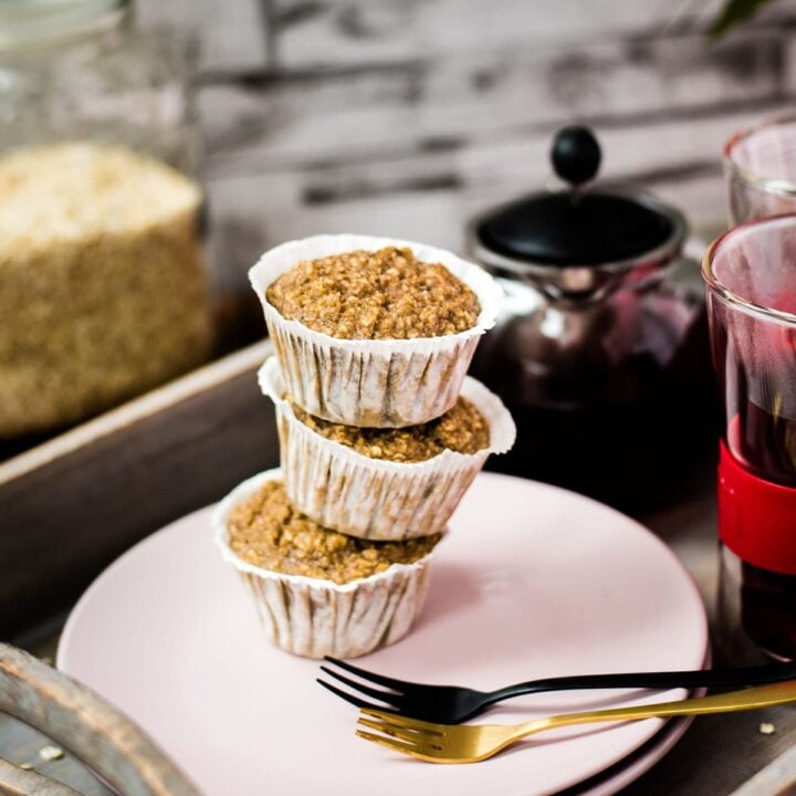 A magnificent tower of banana oatmeal muffins on a wooden tray. Behind it, delicious red tea.