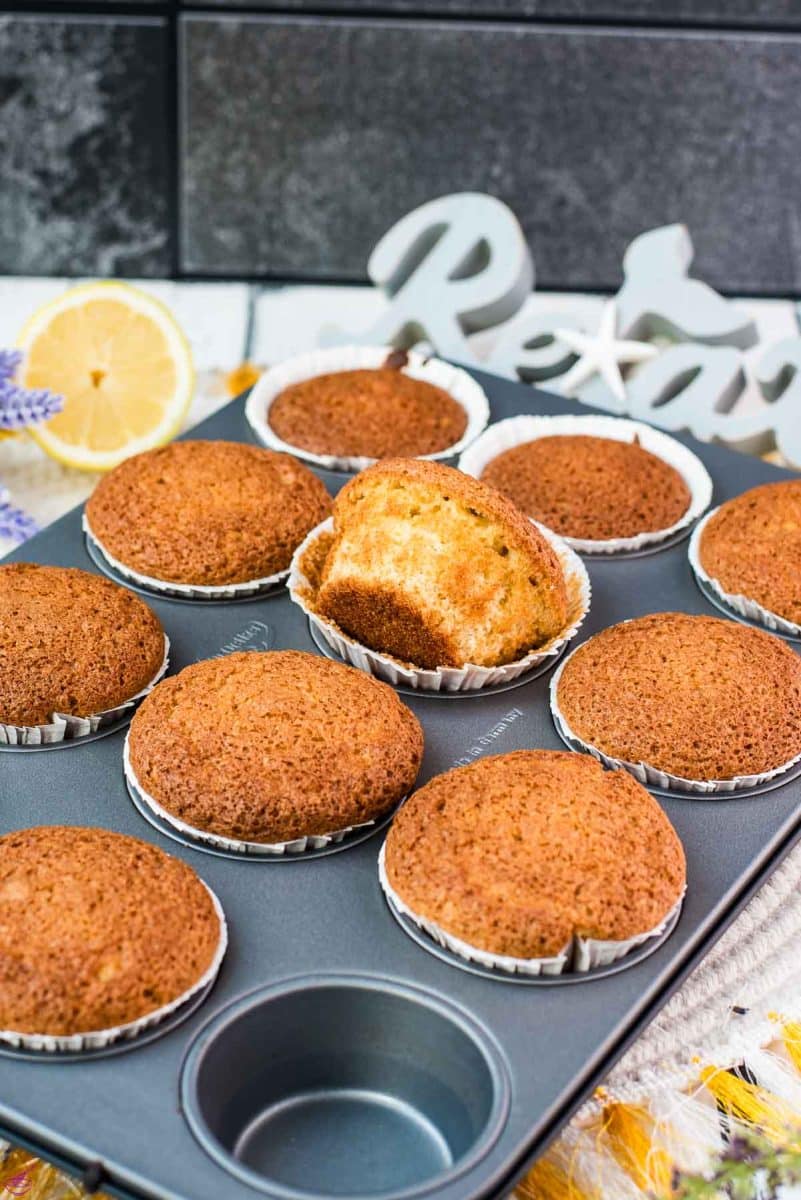 Delicious lavender lemon muffins, placed still in muffin rack. One muffin turned to the side.