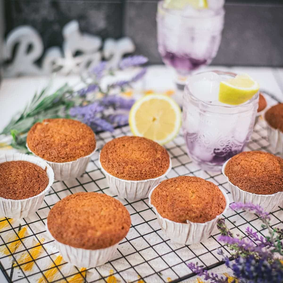 Delicious lavender lemon muffins, placed on cooling rack next to a lemon.