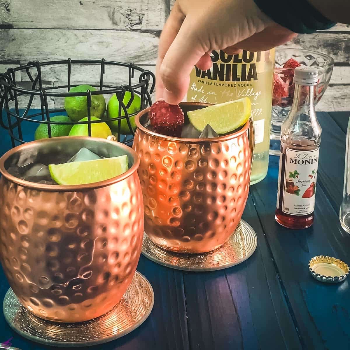 Garnish with a lime wedge and frozen strawberries.