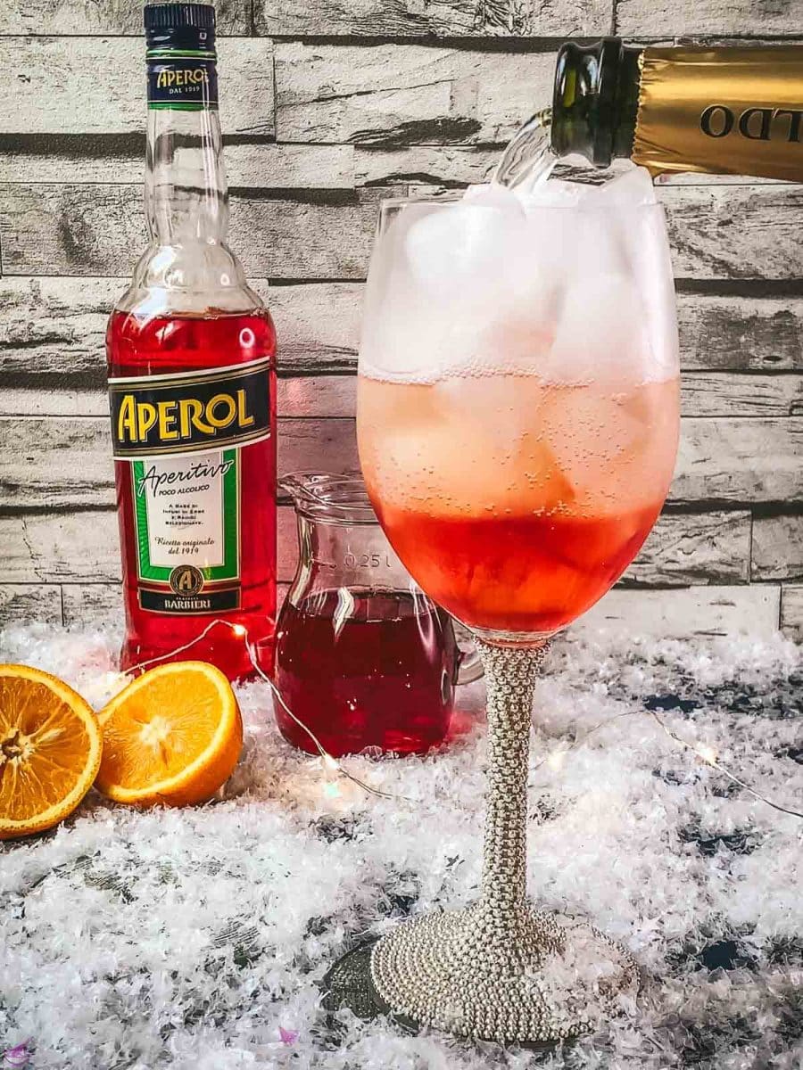 Top the cranberry Aperol with sparkling wine.