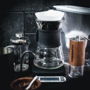 Coffee brewing gear - French press, V60, grinder, scale, gooseneck kettle, and water filter jug.