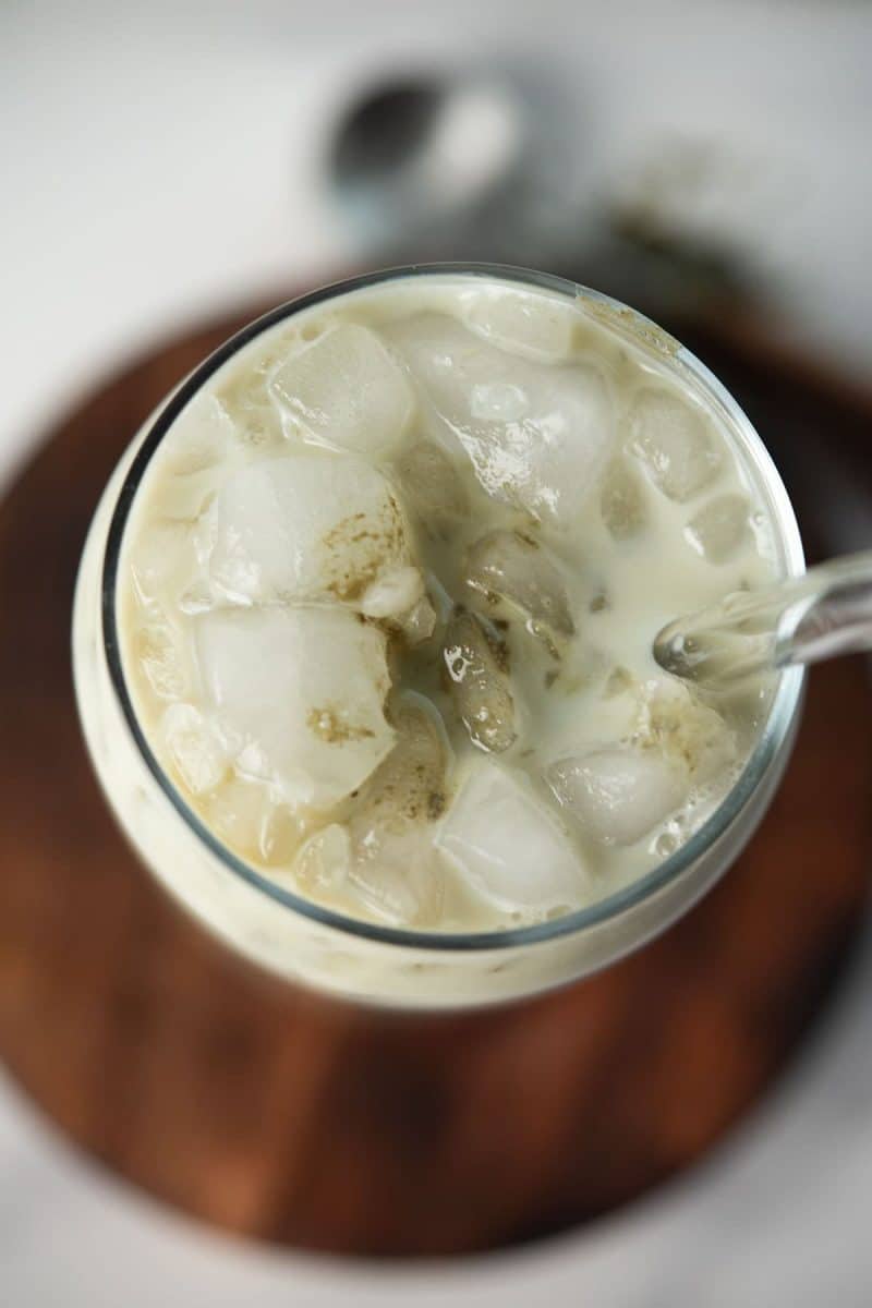 Overhead view of a glass filled with matcha oat milk latte.