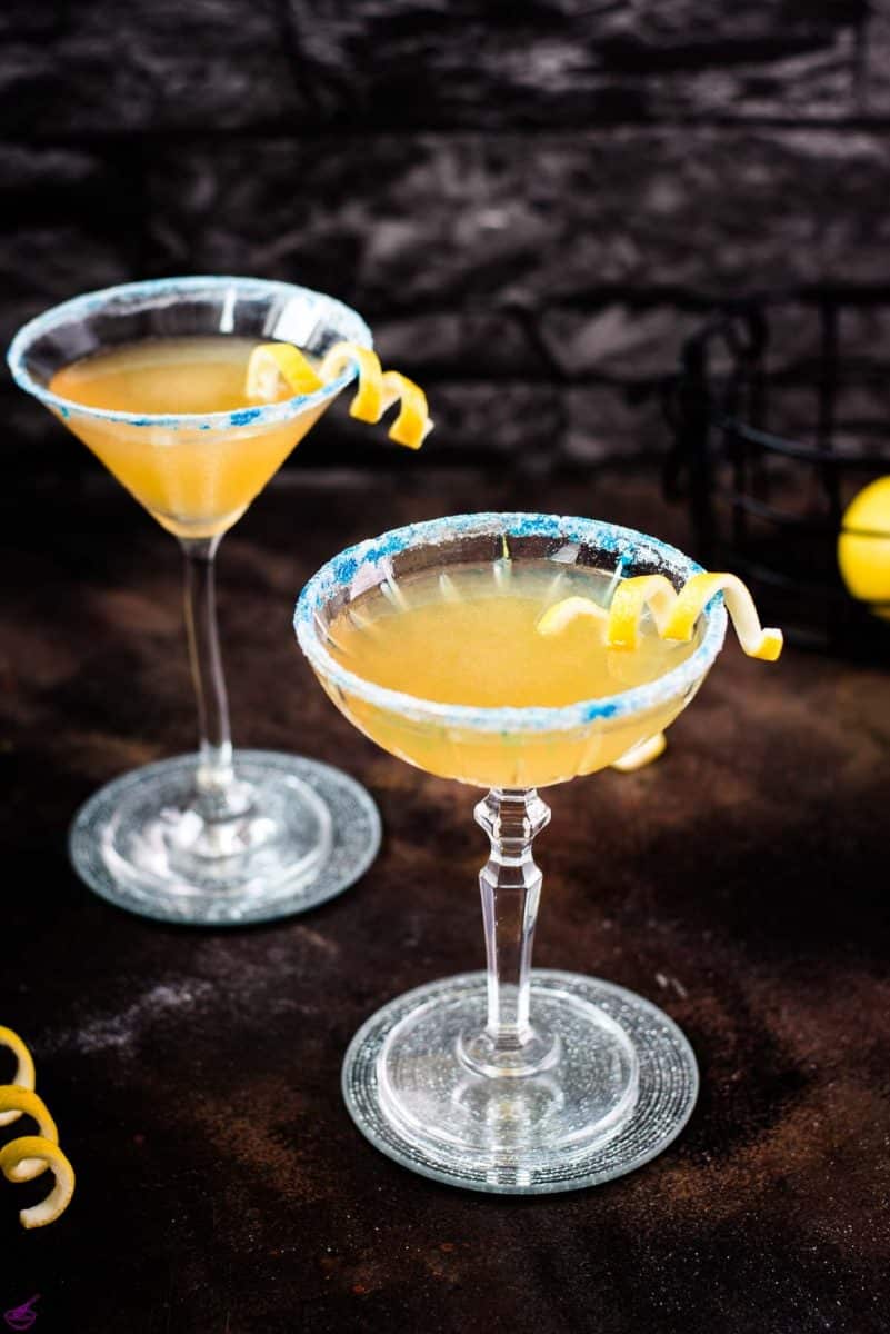 Whiskey sidecar with gorgeous lemon twist and white blue sugar rim.