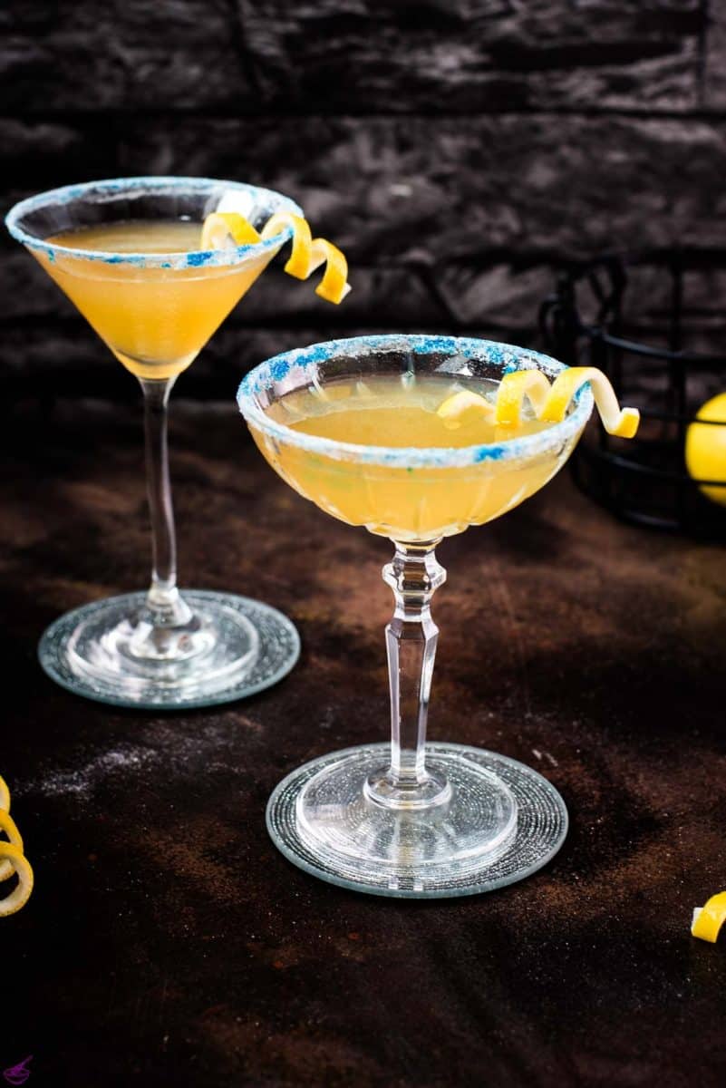 Whiskey sidecar with gorgeous lemon twist and white blue sugar rim.