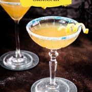 Whiskey sidecar with gorgeous lemon twist and white blue sugar rim.