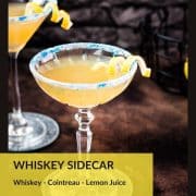 Whiskey sidecar with gorgeous lemon twist and white blue sugar rim.