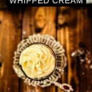 Overhead shot of a delicious espresso whipped cream served on top of a coffee in a medieval styled glass cup.