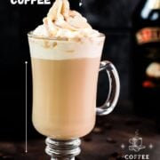 Decadent Bailey'S coffee, served in beautiful glass, placed on dark ground and topped with delicious whipped cream.