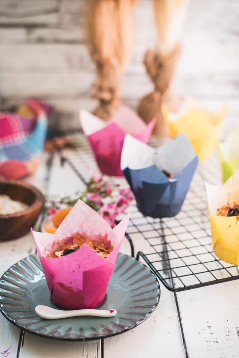 Delicious dried apricot breakfast muffins, with homemade caramel topping, sprinkled with melted chocolate after baking.