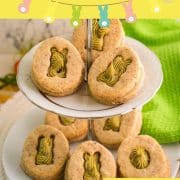 Gorgous cut out Easter cookies with pistachio ganache placed on cute tray.