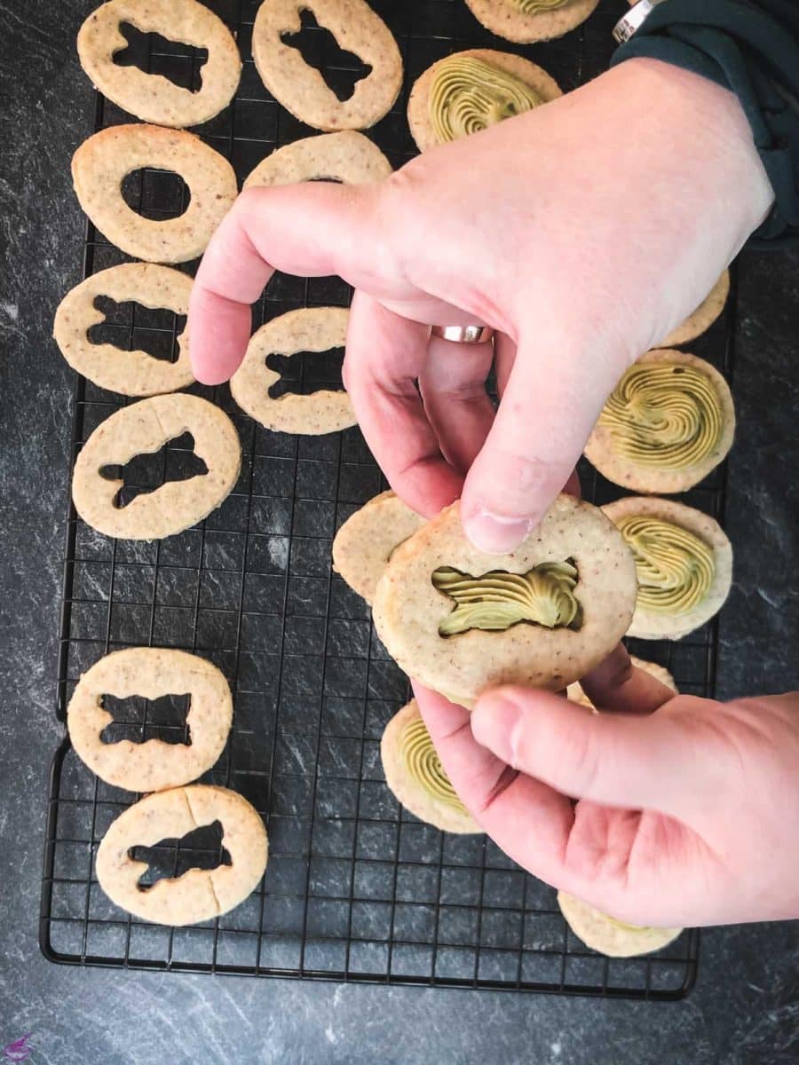 Carefully place the cut-out motif cookie on top of the pistachio ganache.